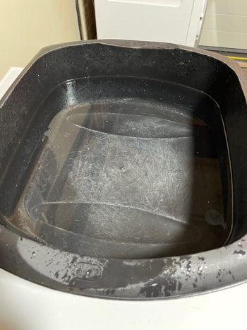 A washing up bowl 80% full of water