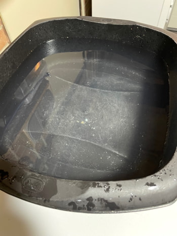 A washing up bowl about 85% full of water